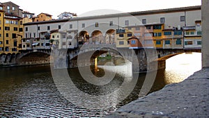 Ponte Vecchio, `Old Bridge`, over the Arno River, sunset view, Florence, Italy