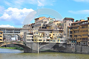 Ponte Vecchio over Arno River, Florence, Italy, Europe. Old bridge with gift shops and houses is famous landmark of Florence. photo