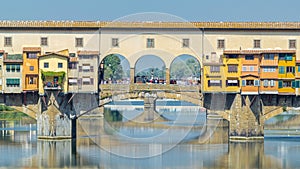 The Ponte Vecchio on a sunny day timelapse, a medieval stone segmental arch bridge over the Arno River, in Florence