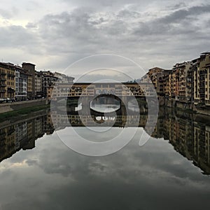 Ponte Vecchio view in Firenze, Tuscany. Cloudy day at the golden bridge in Florence. Ponte Vecchio. Italy. Reflection. Squared.