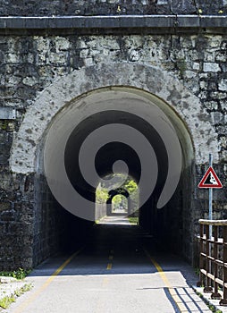 Ponteba Italy July 24th 2018. Ciclovia Alpe Adria placed on former rail way. Old train tunnel on a sunny day. Radweg in Italy photo