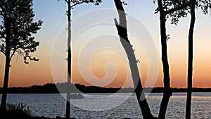 Pontoon on a beautiful Minnesota lake after sunset