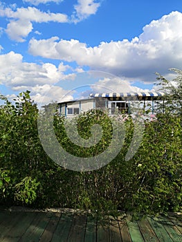 Pontoon boat on the Danube river with white clouds