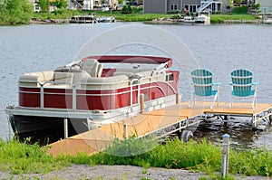 Pontoon Boat Tied to a Dock photo