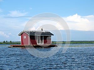 Pontoon house on a river photo