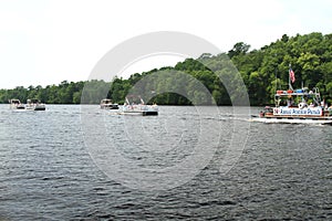 Pontoon parade on the river to celebrate Independence Day, the Fourth of July