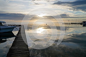 Pontoon pier in yellow night sunset in lake of biscarrosse in landes france