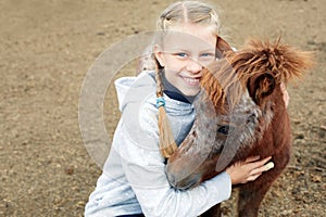 Pony and little girl and her best friend