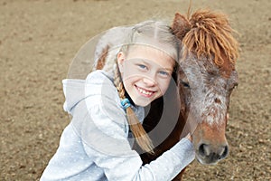 Pony and little girl and her best friend