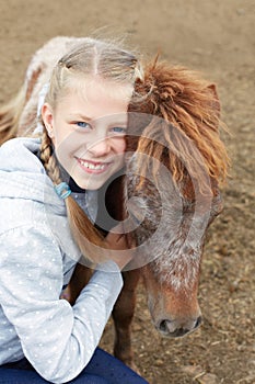 Pony and little girl and her best friend