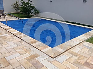 Pool in backyard with a thermal cover