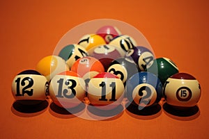 Pool balls pyramid on orange cloth for eightball game