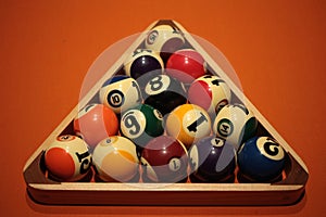 Pool balls pyramid on orange cloth for eightball game