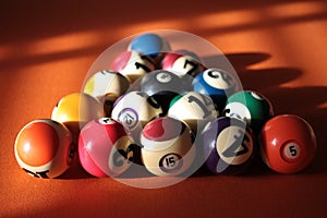 Pool balls pyramid on orange cloth for eightball game