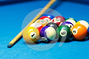 Pool billiard balls and cue on the table