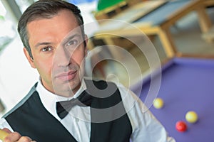 Pool billiard player looking at camera