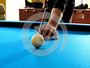 Pool or billiards table with cue ball and blue felt.