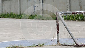 Pool boy kicking old football have laceration and net laceration small goal.