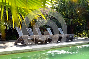 Pool chairs on deck at a hotel in tropics