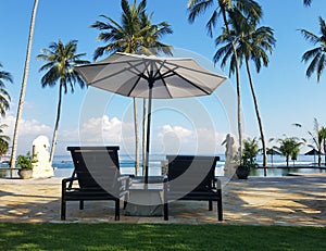 Pool chaise lounges and umbrella