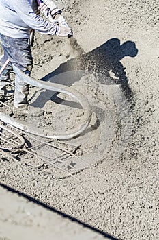 Pool Construction Worker Shooting Concrete, Shotcrete or Gunite Through Hose