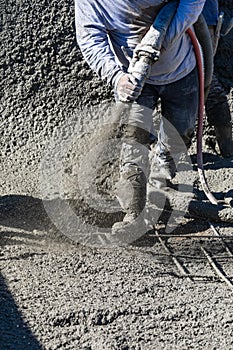 Pool Construction Worker Shooting Concrete, Shotcrete or Gunite Through Hose