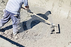Pool Construction Worker Working With A Bullfloat On Wet Concrete