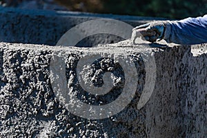 Pool Construction Worker Working With A Smoothing Trowel On Wet Concrete