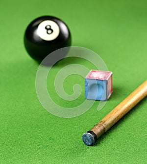 Pool Cue and 8 ball and chalk photo