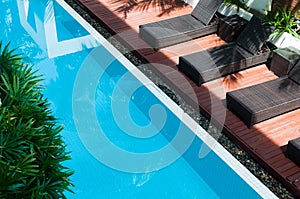 Pool with dark chairs beside