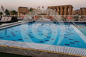 Pool deck and parasols of luxury boat cruise ship in egypt luxor during dawn sunset