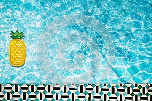 Pool float, ring floating in a refreshing blue swimming pool with palm tree leaf shadows in water