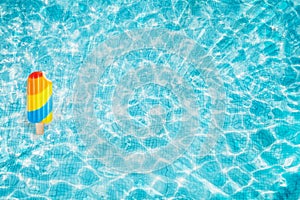 Pool float, ring floating in a refreshing blue swimming pool with palm tree leaf shadows in water