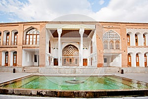 Pool with fountain inside the courtyard of Qajar dinasty historical building Asef mansion