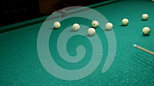 Pool Game. Billiard balls move with cue on the billiard table. Game of inept player on billiards.