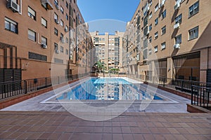 Pool inside a community of neighbors with some palm trees