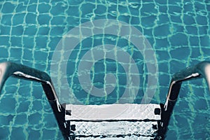 Pool ladders in swimming pool, summer water recreation concept