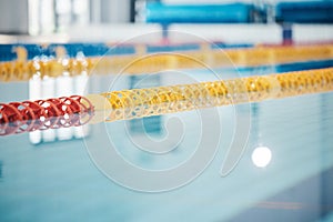 Pool, lanes in water for competition or racing lines for fitness or underwater sports empty with reflection. Exercise