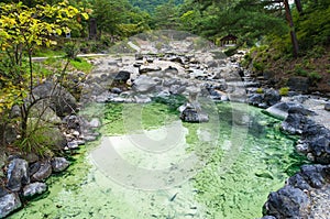 Pool with mineral hot spring water in Kusatsu park in Japan