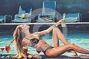 Pool party relax in spa resort. Cocktail with fruit at sexy girl in pool on maldives. Fashion woman with refresh alcohol