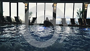 pool with poolside loungers reflecting in the water, luxury concept shot