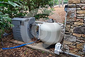 Home pool pump equipment for filtering and maintaining clean water photo