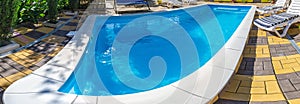 Pool with pure blue water background. Top view of swimming pool and floor texture Panorama of pool bottom with tile pattern and