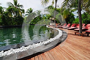 Pool and red lounge chairs