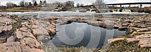 Pool reflection of the sky with the Big Sioux River in Sioux Falls South Dakota with views of wildlife, ruins, park paths, train t