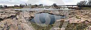 Pool reflection of the sky with the Big Sioux River in Sioux Falls South Dakota with views of wildlife, ruins, park paths, train t