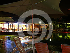 Pool and restaurant in night.