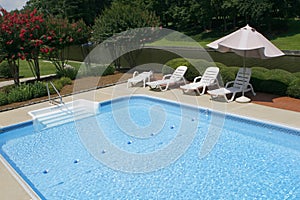 Pool Side with Lounge Chairs and Umbrella