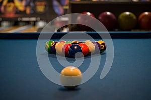 Pool table with colorful billiard balls places in a triangle