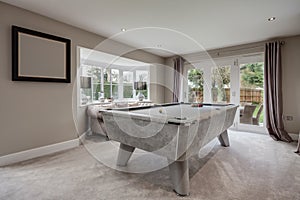 Pool table and sofa in luxury home